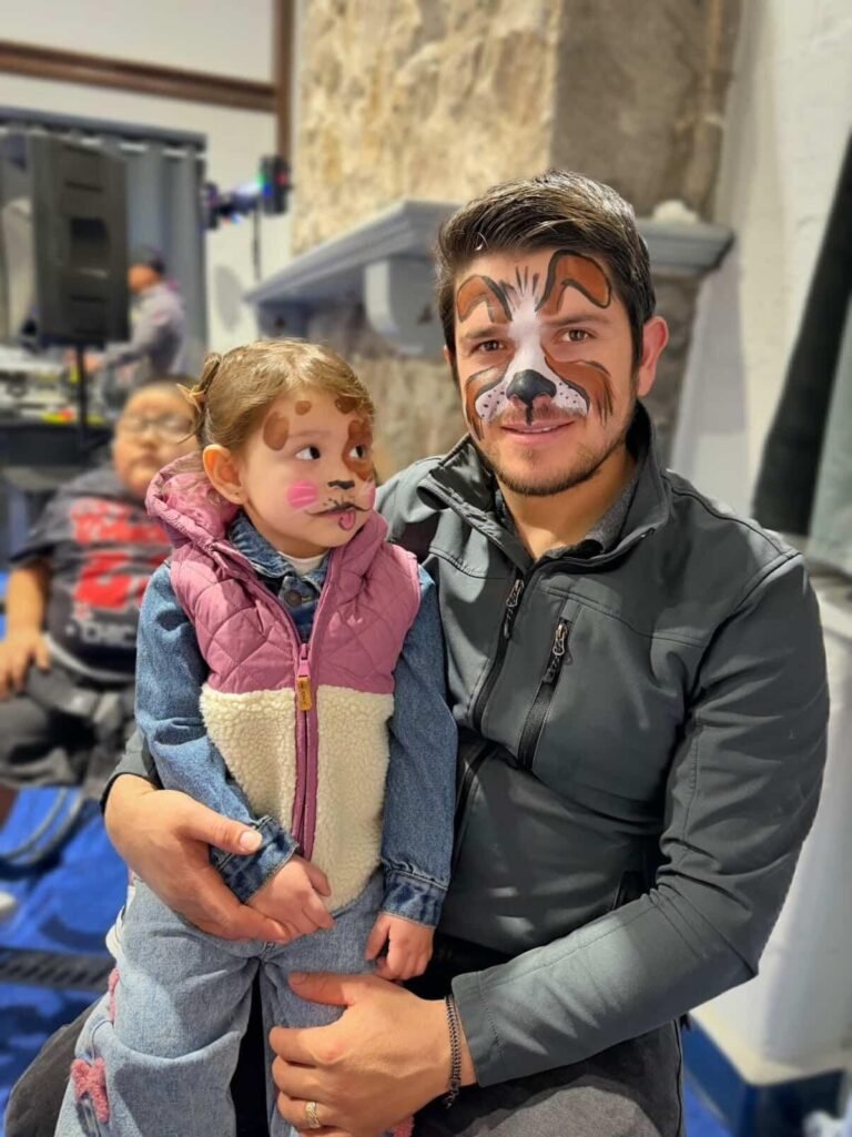 Dad and child with face painting at a party