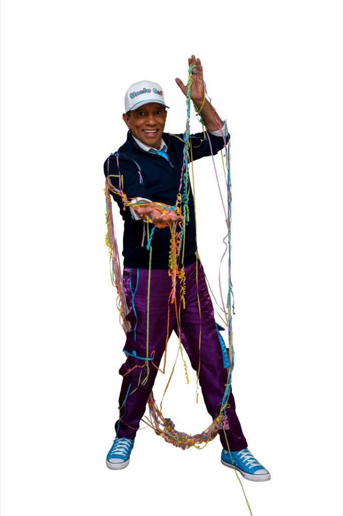 Uncle Raf playing with a hula hoop during an interactive kids show
